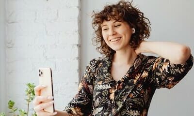 Person wearing AirPods, with an iPhone