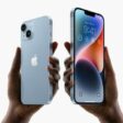 Two hands hold up iPhone 14 and iPhone 14 Plus.