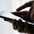 Person typing on iPhone screen