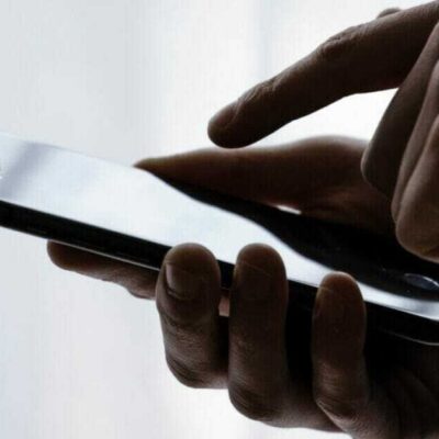 Person typing on iPhone screen