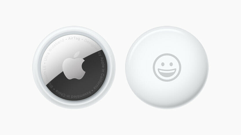 Front and back view of AirTag personalised with a smiley-face emoji.