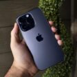 Person holding iPhone 14 Pro with back of the phone to camera