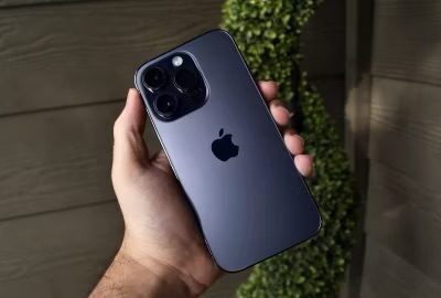 Person holding iPhone 14 Pro with back of the phone to camera