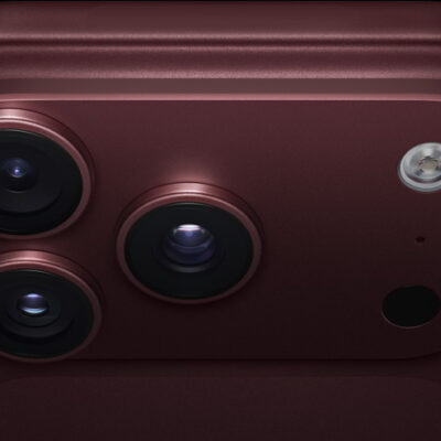 iPhone 18 Pro, burgundy finish, partial back exterior angled to show pro camera system in top left corner, 3 lenses, microphone, flash
