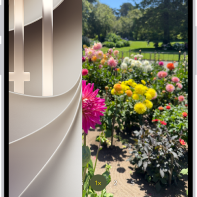 The iPhone screen showing the Lock Screen sliding to the left and the Camera open on the right side of the screen.