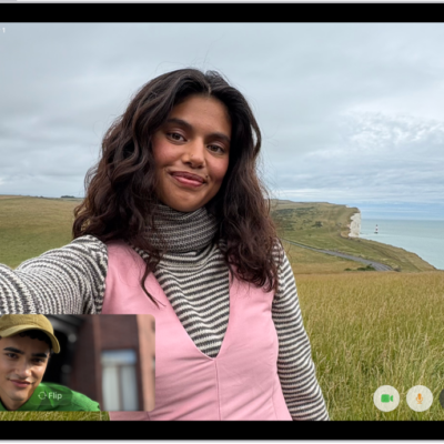 A FaceTime video call in progress, showing one participant at the bottom left. An image of three other participants fills the rest of the screen. At the bottom right are the Camera, Microphone, More, and End Call buttons.