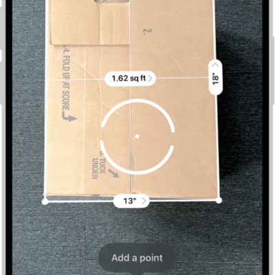 A screen showing the measurement of the dimensions of a box in the Measure app. The area of the box is calculated from the measurements of the dimensions.