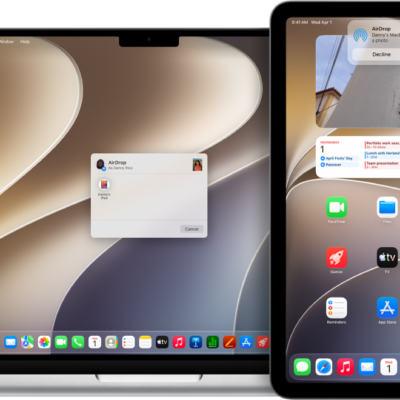A Mac is next to an iPad. The AirDrop dialog is open on the Mac desktop, ready to share a document with the iPad. The iPad screen has a notification about receiving the document.