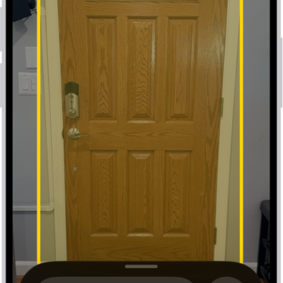 The Magnifier app is open and a door is being detected. A description shows how far away the door is.