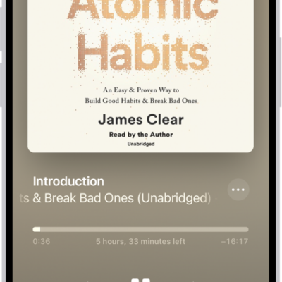 The audiobook player screen showing, from top to bottom, the audiobook cover, the name of the section that's playing, the playhead, pause button, and the skip forward and back buttons. At the bottom is the volume slider and below that are buttons for controlling playback speed, setting a sleep timer, choosing a playback destination, and viewing a list of the book's tracks.