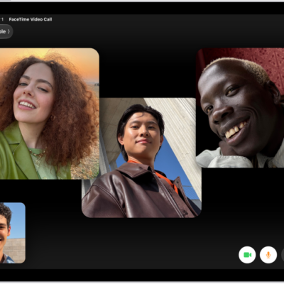 A Group FaceTime call showing four participants in individual tiles at the top of the screen. Two additional participants appear together in a tile at the bottom left. At the bottom right are FaceTime controls: the Video, Microphone, More, and End Call buttons.