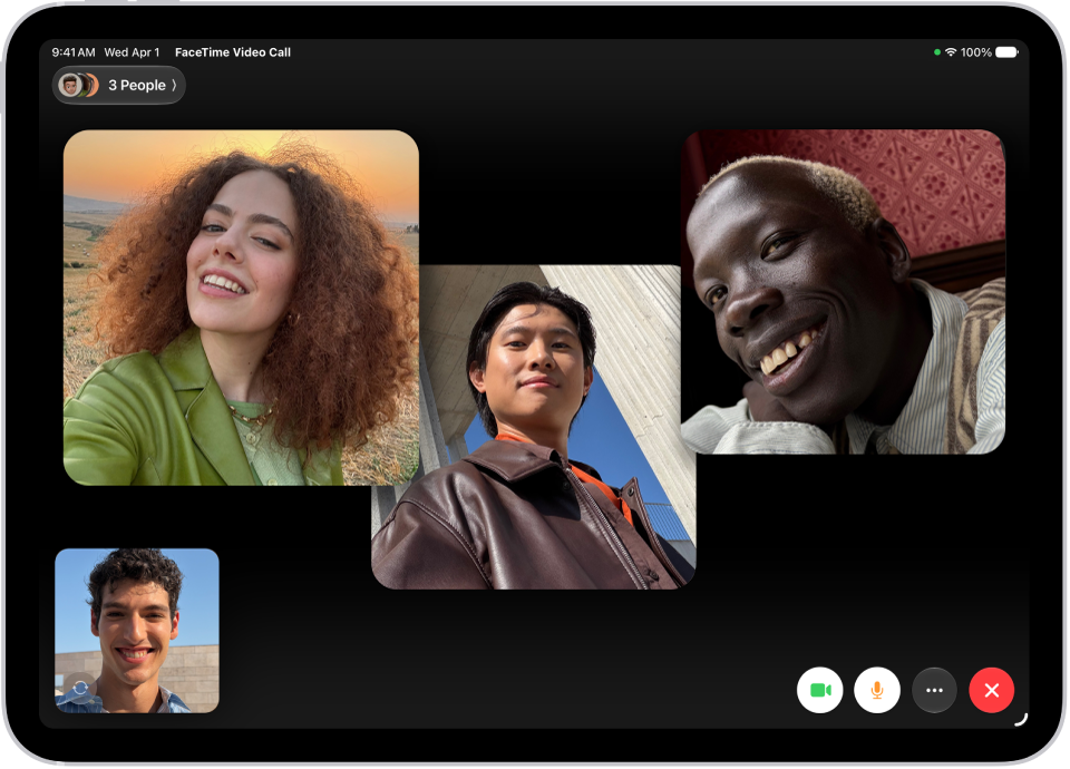A Group FaceTime call showing four participants in individual tiles at the top of the screen. Two additional participants appear together in a tile at the bottom left. At the bottom right are FaceTime controls: the Video, Microphone, More, and End Call buttons.