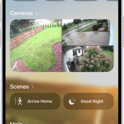 The Home tab showing, from top to bottom, four categories, two scenes, three camera views, and the status of one room. Across the bottom are the tabs Home (which is selected), Automation, and Discover.