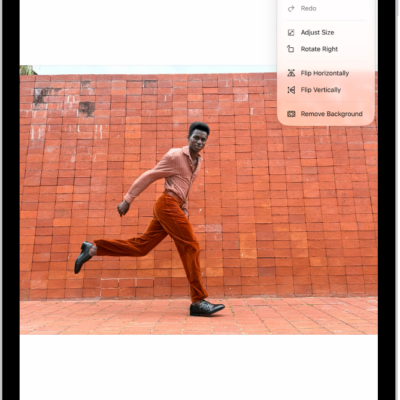 Preview app window showing a photo with a hand holding grapes in the foreground. The background of the photo shows the sky and the ocean.