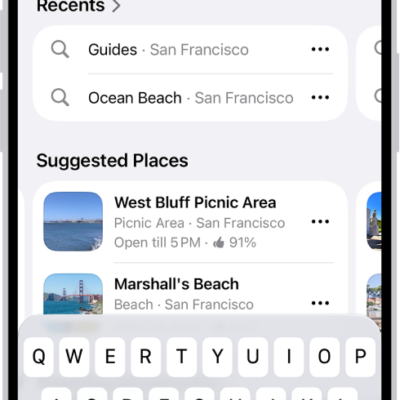 The Maps app showing the search field, categories for nearby services, and city guides. In the bottom part of the screen is the iPhone onscreen keyboard.