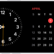 iPhone turned horizontally. The left side of the screen displays a clock and the right side of the screen displays the date.