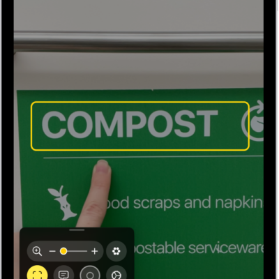 The Magnifier app detecting a finger pointing at text on a sign.