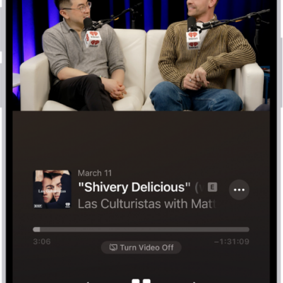 The Now Playing screen in the Podcasts app, showing a video. Below the video is the podcast artwork, the episode title, the playback controls, and the volume slider. At the bottom of the tab are the View Transcript button, the AirPlay icon, and the Playing Next button.