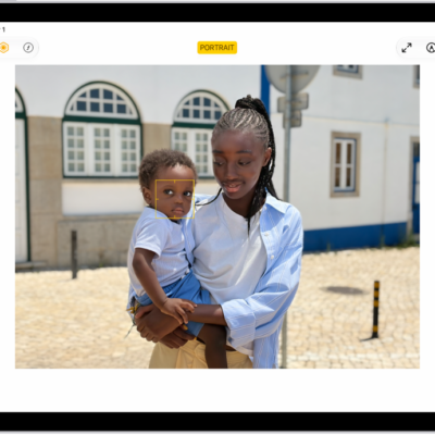 The Edit screen of a Portrait mode photo. The photo is in the center of the screen and on the right side of the screen are the Portrait Lighting effect options. Stage Light is selected and there is a slider to adjust the level of the effect. On the left side of the screen are the Portrait, Adjust, Filters, and Crop buttons. The Portrait button is selected.