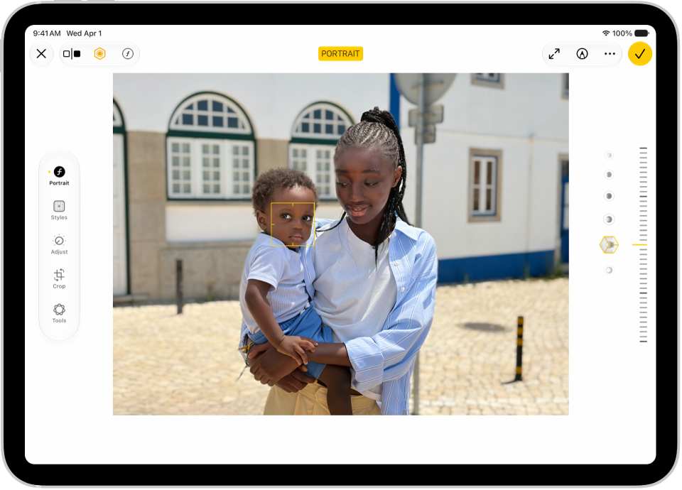 The Edit screen of a Portrait mode photo. The photo is in the center of the screen and on the right side of the screen are the Portrait Lighting effect options. Stage Light is selected and there is a slider to adjust the level of the effect. On the left side of the screen are the Portrait, Adjust, Filters, and Crop buttons. The Portrait button is selected.