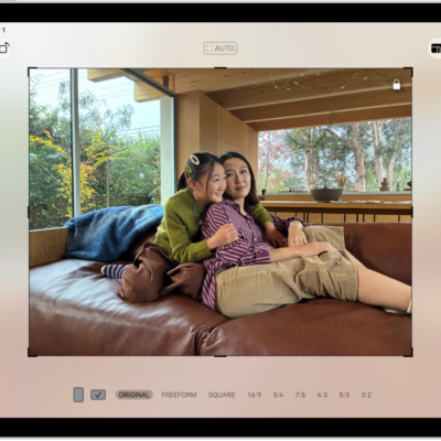 The Edit screen in the Photos app with a photo in the center. On the left side of the screen are the Adjust, Filters, and Crop buttons; the Crop button is selected. On the right side of the screen are the crop enhancement options and a slider to adjust the level of the effect.