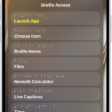 An iPhone with the Braille Access menu open, showing the following options: Launch App, Choose Item, Braille Notes, BRF Files, Nemeth Calculator, Live Captions, and Time.